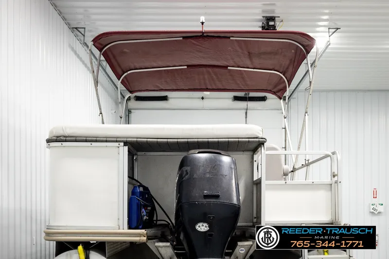 Slide: The Image of 2003 Fisher 220 FISH boat with canopy and motor in indoor storage. - 7