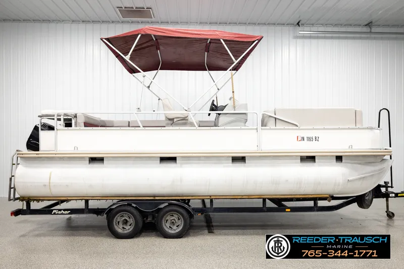 Slide: The Image of 2003 Fisher 220 FISH pontoon boat with red canopy on trailer in indoor storage. - 5