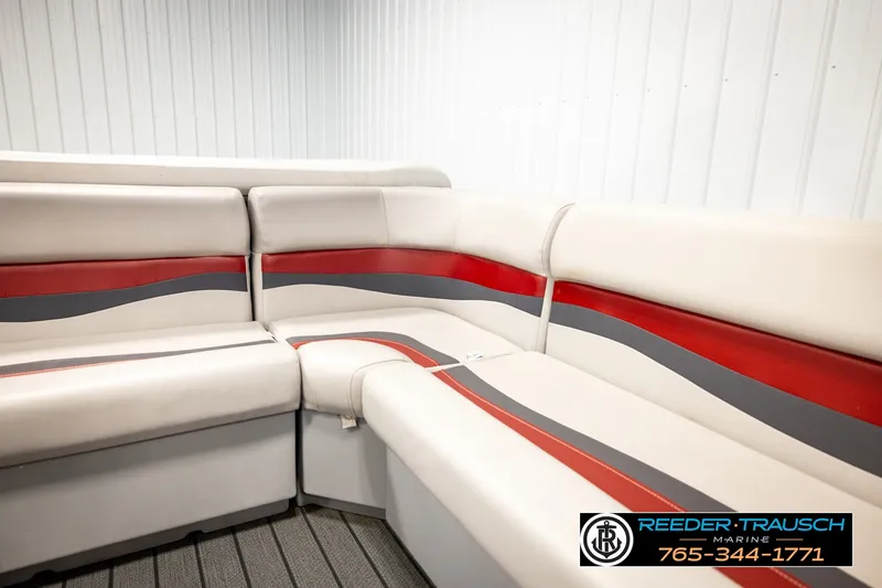 Slide: The Image of 2003 Fisher 220 FISH boat interior with red and gray seating in a marine showroom. - 28