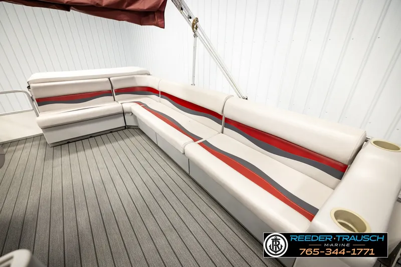 Slide: The Image of 2003 Fisher 220 FISH boat interior with red and gray striped seating. - 20