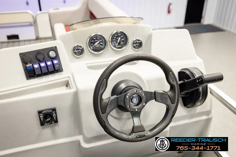 Slide: The Image of Steering console of a 2003 Fisher 220 FISH boat with gauges and controls. - 23