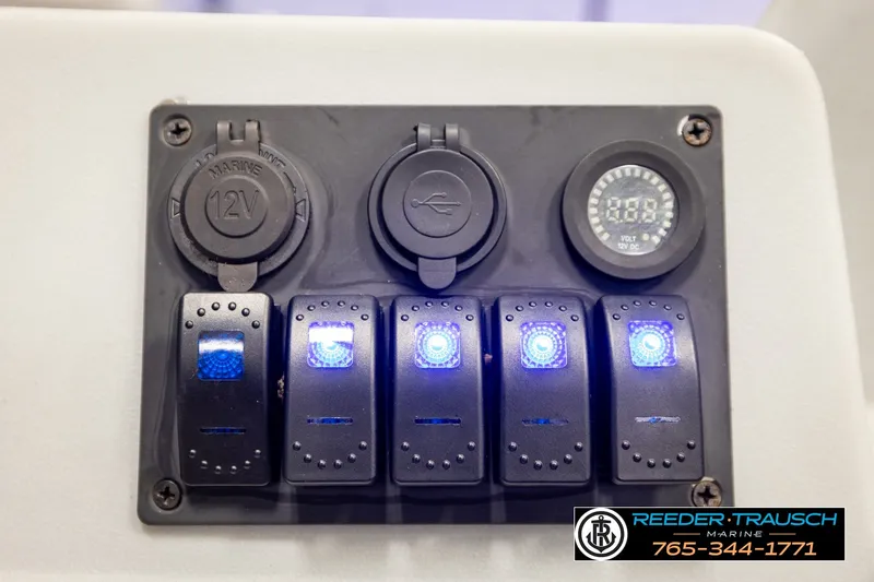 Slide: The Image of Control panel with illuminated switches on a 2003 Fisher 220 FISH boat. - 24