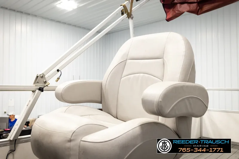 Slide: The Image of Comfortable captain's chair on 2003 Fisher 220 FISH boat, in a well-lit indoor setting. - 27