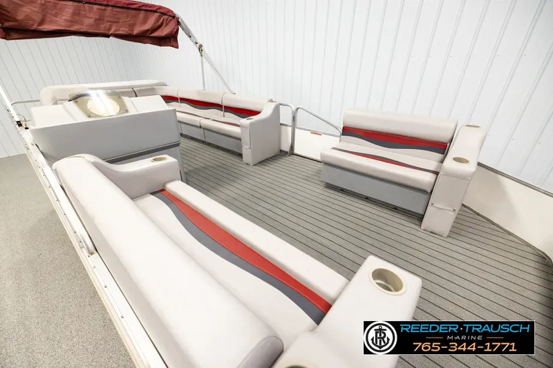 Slide: The Image of 2003 Fisher 220 FISH pontoon boat interior with gray and red seating, cup holders, and canopy. - 9