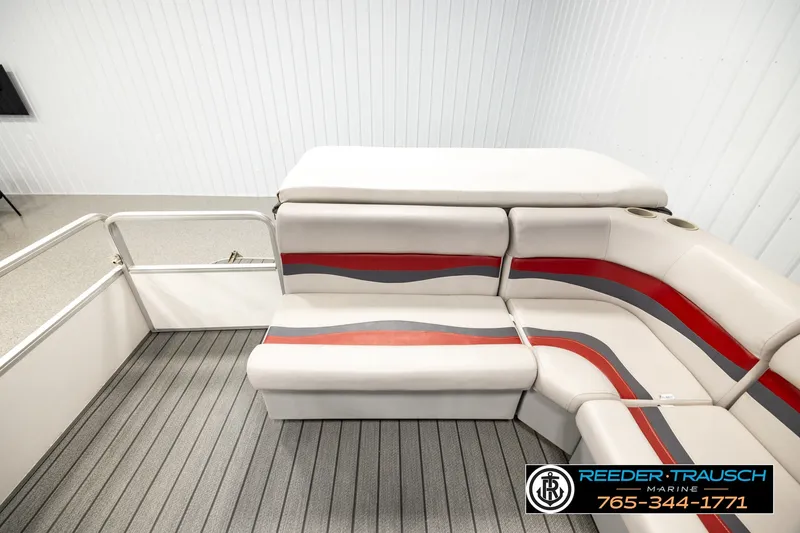 Slide: The Image of 2003 Fisher 220 FISH boat interior with red and gray seating, cup holders, and striped flooring. - 15