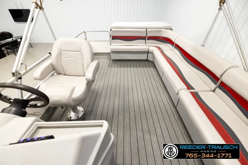 Slide: The Image of Interior of a 2003 Fisher 220 FISH boat with seating and steering wheel. - 14