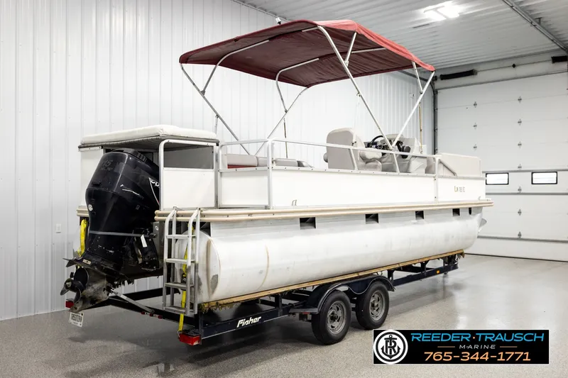 Slide: The Image of 2003 Fisher 220 FISH pontoon boat with canopy, on trailer in indoor storage. - 6