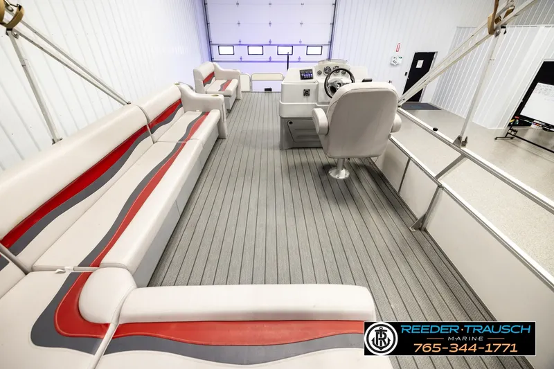Slide: The Image of Interior of 2003 Fisher 220 FISH boat with seating and steering console. - 16