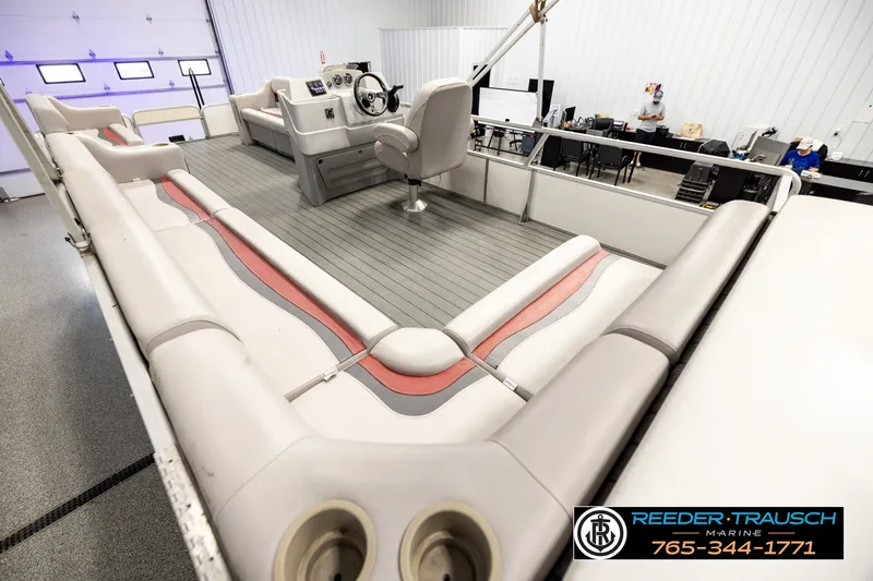 Slide: The Image of 2003 Fisher 220 FISH pontoon boat interior with seating and steering console in showroom. - 11