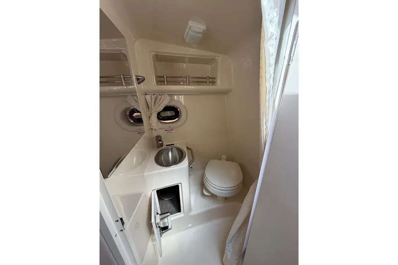 Slide: The Image of 2016 Sea Ray Sundancer 260 boat bathroom with sink, toilet, and storage. - 50
