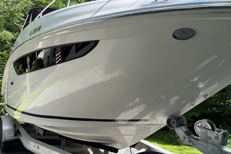Slide: The Image of 2016 Sea Ray Sundancer 260 boat on trailer, side view with sleek design. - 4
