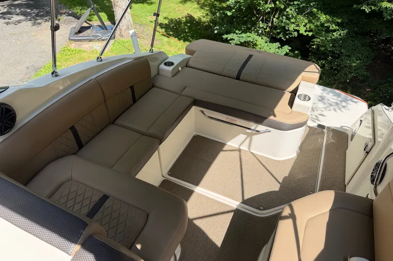 Slide: The Image of Luxurious seating area on a 2016 Sea Ray Sundancer 260 boat, featuring tan upholstery. - 26
