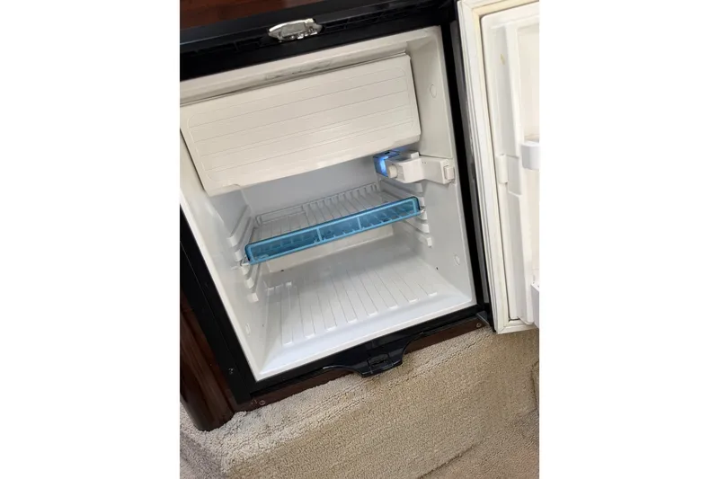 Slide: The Image of Open mini fridge inside 2016 Sea Ray Sundancer 260 boat cabin. - 59