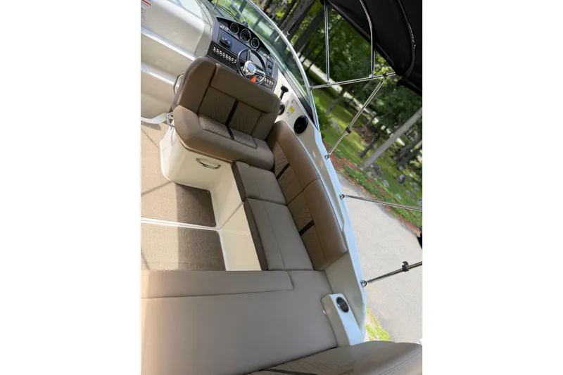 Slide: The Image of 2016 Sea Ray Sundancer 260 interior with plush seating and modern dashboard. - 30