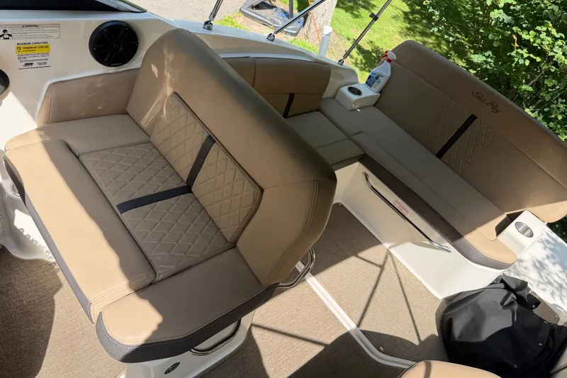 Slide: The Image of 2016 Sea Ray Sundancer 260 interior with beige seating and cup holder. - 28