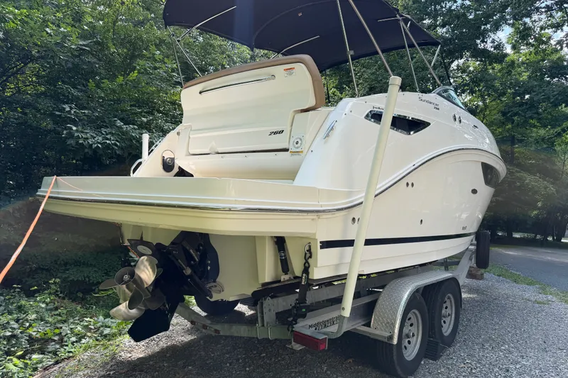 Slide: The Image of 2016 Sea Ray Sundancer 260 boat on trailer, surrounded by trees. - 15