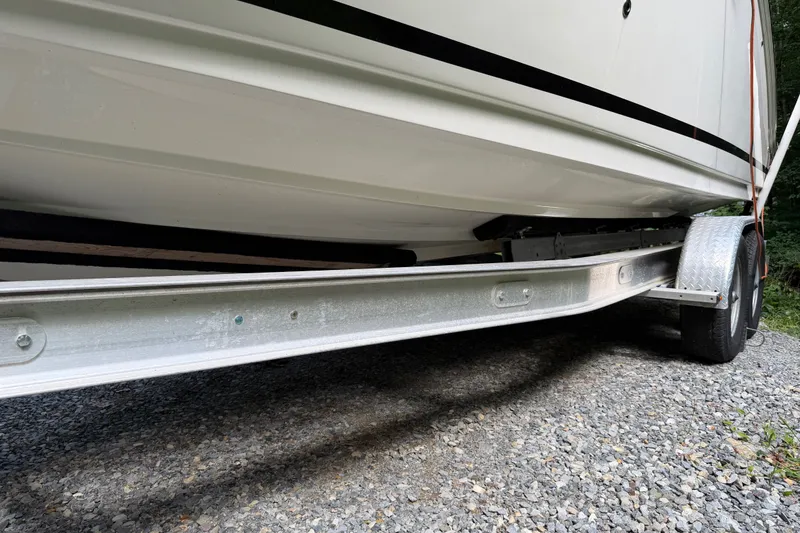 Slide: The Image of 2016 Sea Ray Sundancer 260 boat on trailer, side view, parked on gravel. - 68