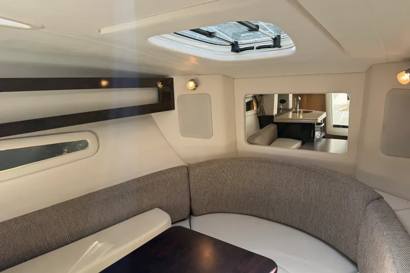 Slide: The Image of Interior of 2016 Sea Ray Sundancer 260, featuring cozy seating and modern design elements. - 38
