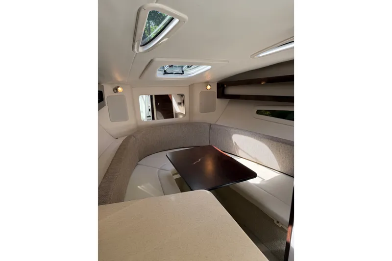 Slide: The Image of Interior of 2016 Sea Ray Sundancer 260, featuring cozy seating and natural light. - 34