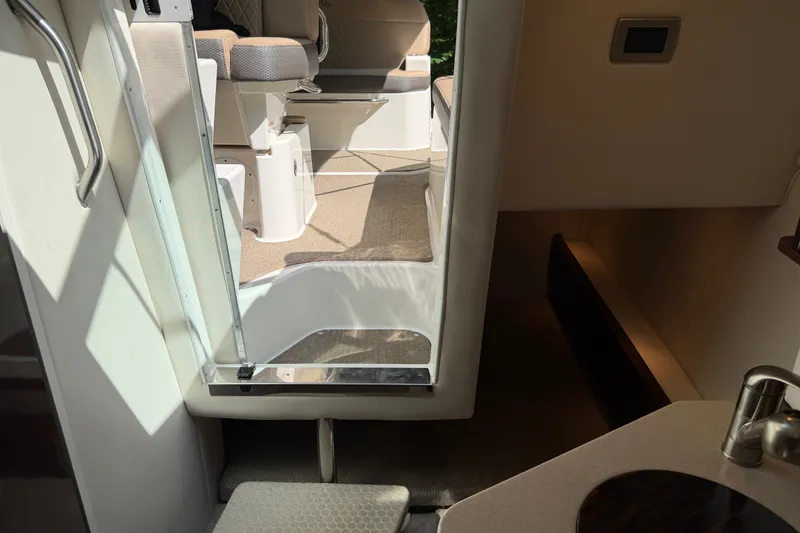 Slide: The Image of Interior view of 2016 Sea Ray Sundancer 260, showcasing seating and cabin entrance. - 39