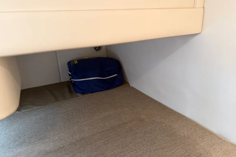 Slide: The Image of Interior cabin storage of 2016 Sea Ray Sundancer 260 with blue bag. - 62