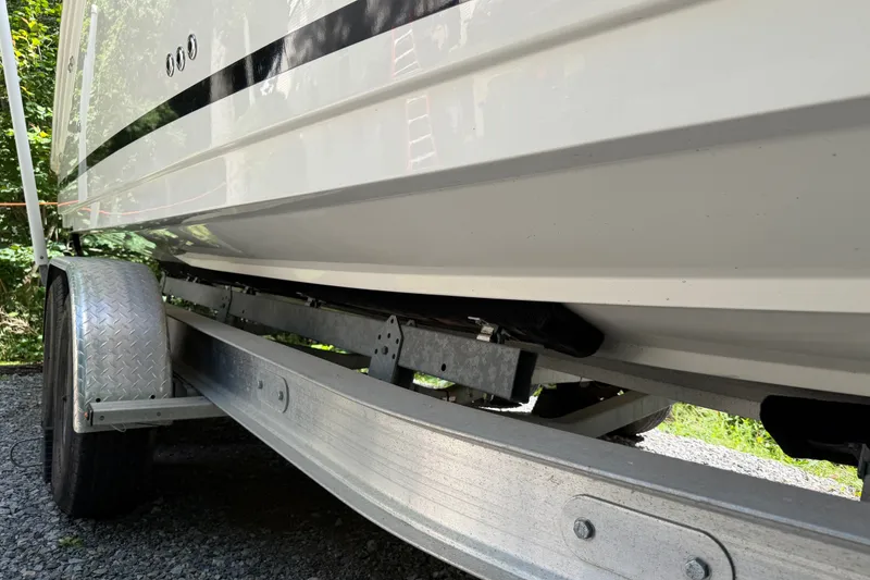 Slide: The Image of 2016 Sea Ray Sundancer 260 on trailer, side view, parked on gravel. - 6