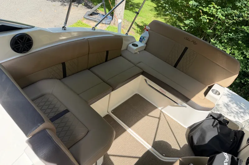 Slide: The Image of 2016 Sea Ray Sundancer 260 interior with beige seating and cup holders. - 29