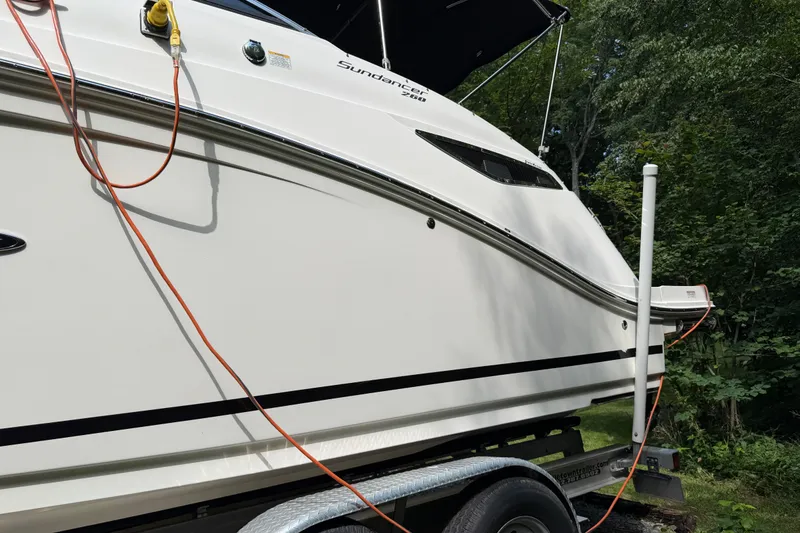 Slide: The Image of 2016 Sea Ray Sundancer 260 boat on trailer, side view with cables attached. - 12