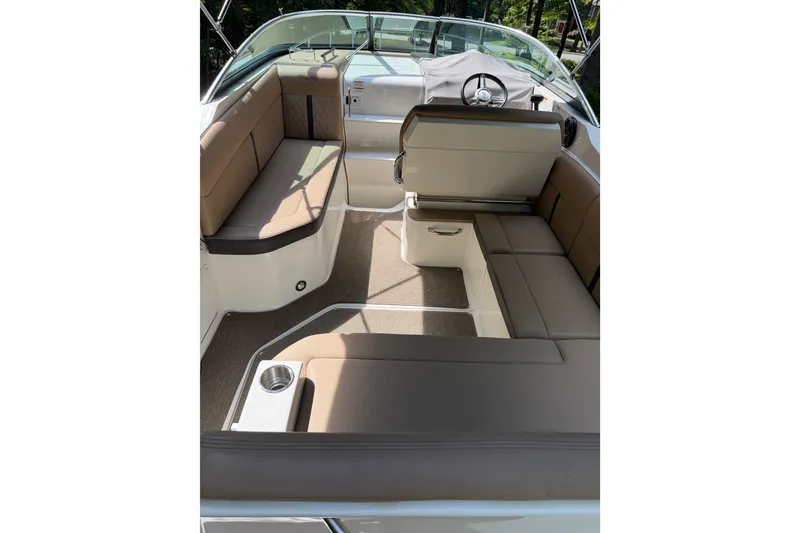 Slide: The Image of 2016 Sea Ray Sundancer 260 interior with beige seating and steering wheel. - 24