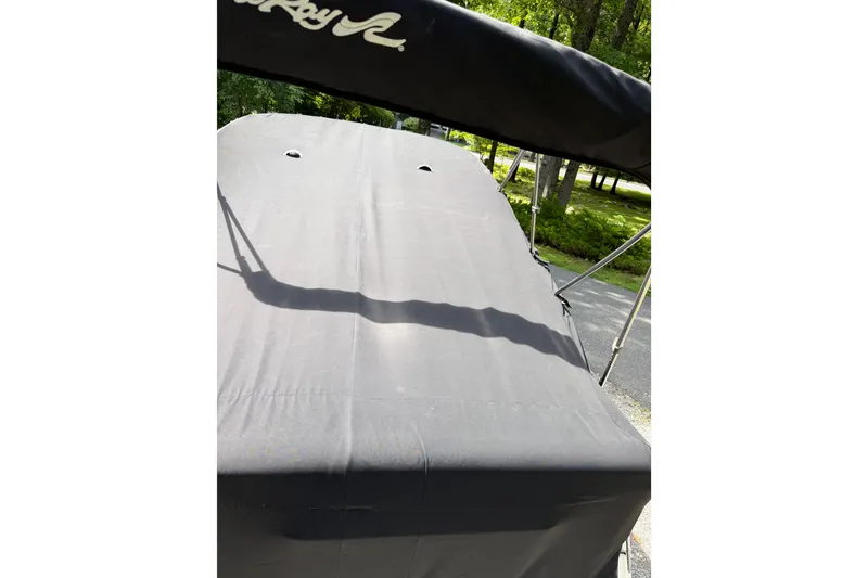 Slide: The Image of 2016 Sea Ray Sundancer 260 boat with black canvas cover and bimini top. - 71