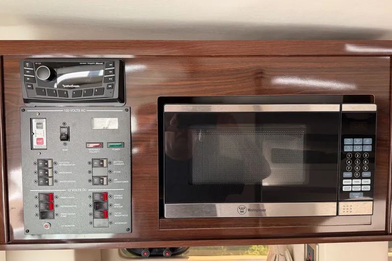 Slide: The Image of Control panel and microwave in 2016 Sea Ray Sundancer 260 boat interior. - 45