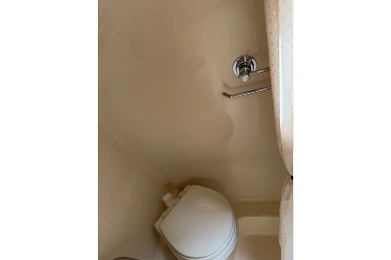 Slide: The Image of Bathroom interior of 2016 Sea Ray Sundancer 260 boat, featuring a compact toilet. - 53