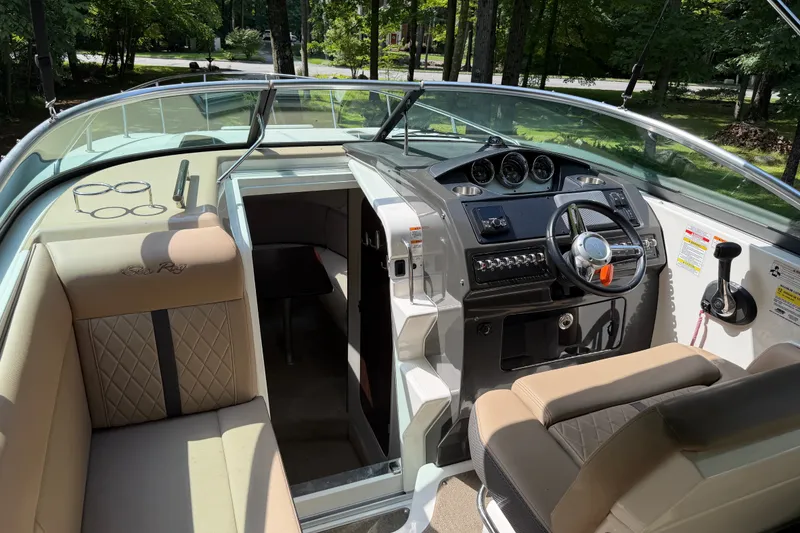 Slide: The Image of Interior view of 2016 Sea Ray Sundancer 260 boat, featuring helm and seating area. - 27