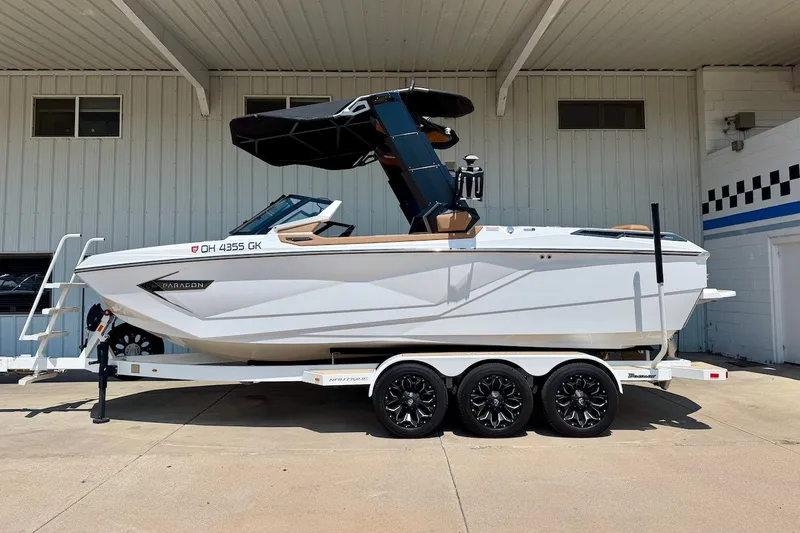 The Image of 2022 Nautique Super Air Nautique G23 Paragon boat on trailer, parked outdoors. - 1