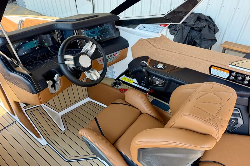 Slide: The Image of Interior of 2022 Nautique Super Air Nautique G23 Paragon with luxurious seating and advanced controls. - 14
