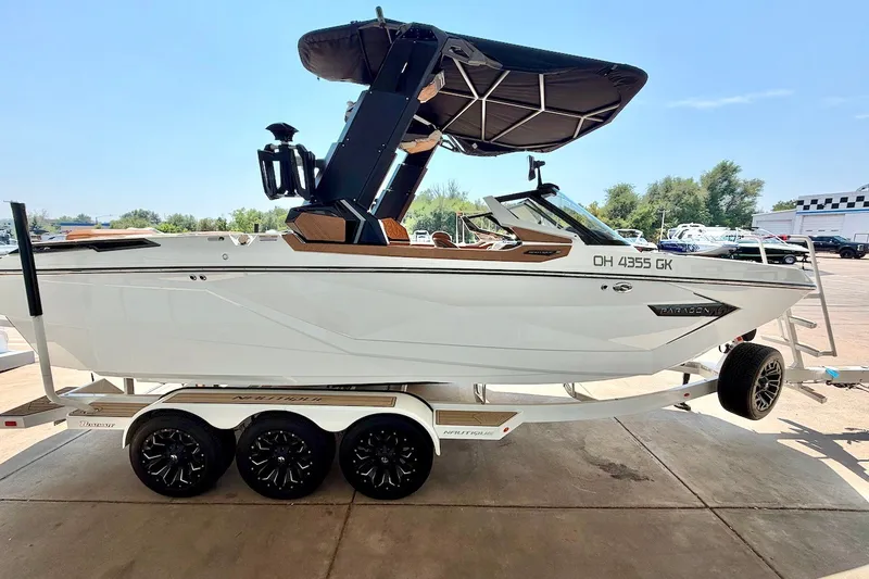 Slide: The Image of 2022 Nautique Super Air Nautique G23 Paragon boat on trailer, side view. - 8