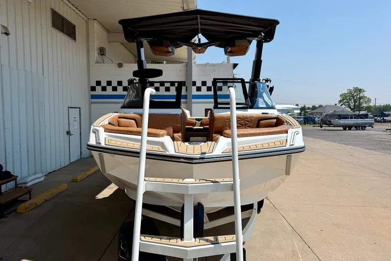 Slide: The Image of 2022 Nautique Super Air Nautique G23 Paragon boat with tan seating, docked outdoors. - 10