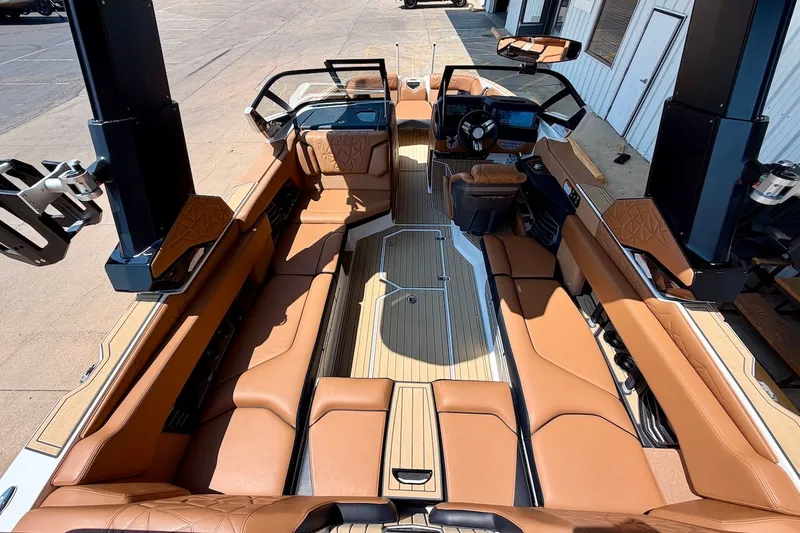 Slide: The Image of 2022 Nautique Super Air Nautique G23 Paragon interior with luxurious tan seating and modern dashboard. - 13