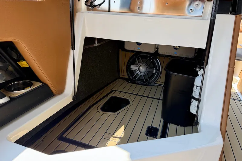 Slide: The Image of 2022 Nautique Super Air Nautique G23 Paragon interior storage with speaker and fire extinguisher. - 22