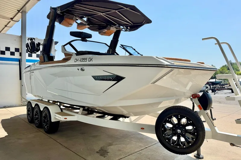 Slide: The Image of 2022 Nautique Super Air Nautique G23 Paragon on trailer, sleek design, under canopy. - 9
