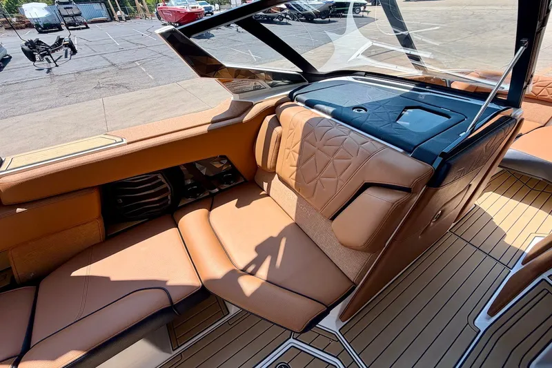 Slide: The Image of 2022 Nautique Super Air Nautique G23 Paragon interior with luxurious tan seating and sleek design. - 17