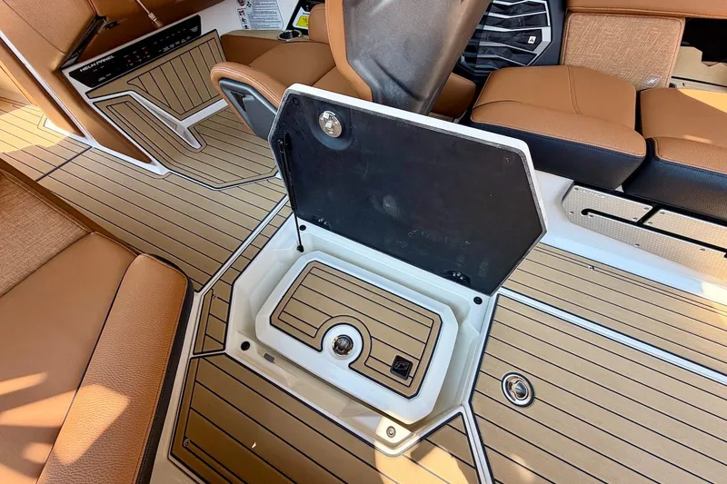 Slide: The Image of 2022 Nautique Super Air Nautique G23 Paragon interior with open storage compartment. - 21