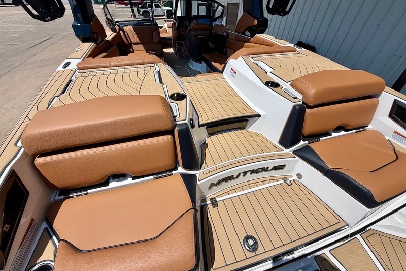 Slide: The Image of 2022 Nautique Super Air Nautique G23 Paragon interior with tan seating and sleek design. - 11