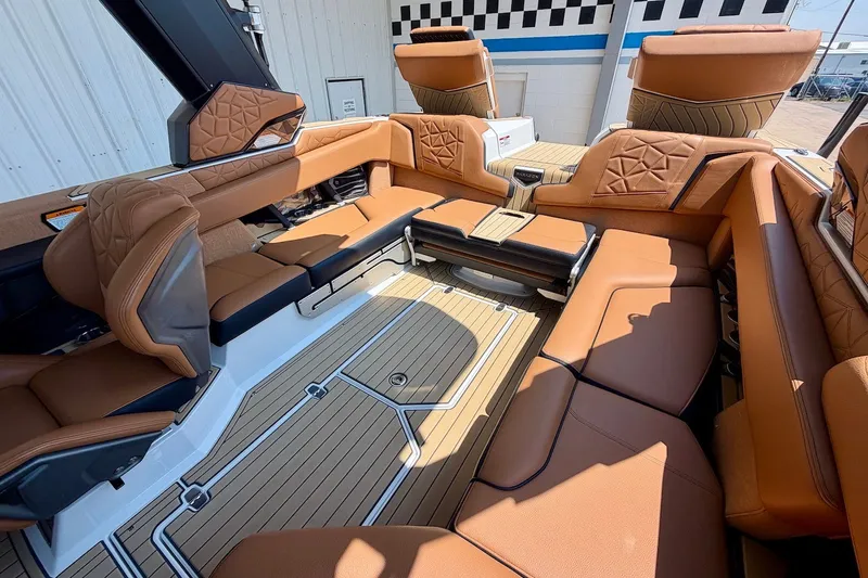 Slide: The Image of Luxurious interior of 2022 Nautique Super Air Nautique G23 Paragon boat with tan seating. - 18