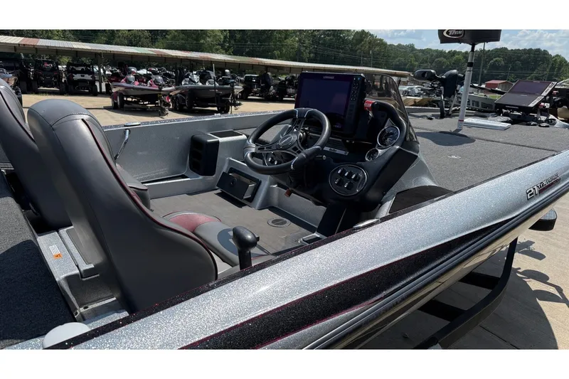 Slide: The Image of 2024 Triton 21 TrX Patriot boat interior with steering console and seating. - 9