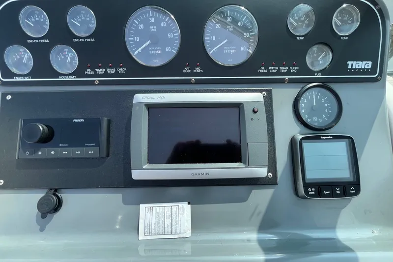 Slide: The Image of Dashboard of a 2001 Tiara Yachts 2900 Coronet with gauges and navigation equipment. - 18