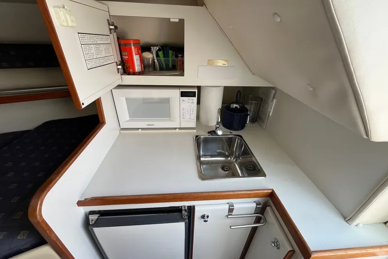 Slide: The Image of Compact galley in 2001 Tiara Yachts 2900 Coronet with microwave, sink, and storage. - 31