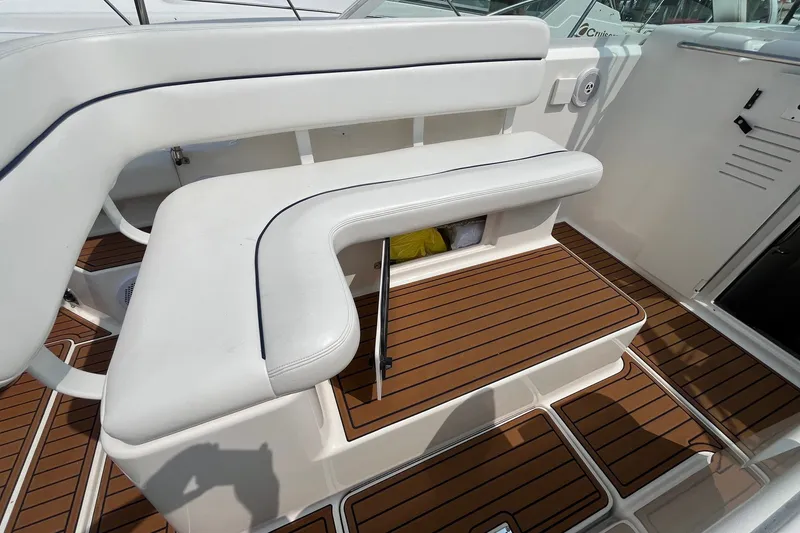 Slide: The Image of 2001 Tiara Yachts 2900 Coronet interior with white seating and teak flooring. - 15