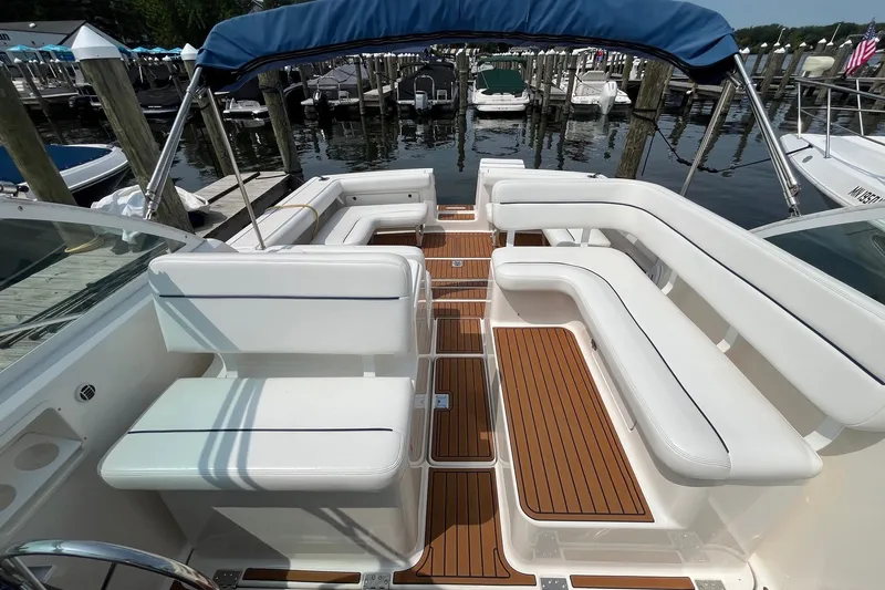 Slide: The Image of 2001 Tiara Yachts 2900 Coronet with white seating and teak flooring at a marina. - 21