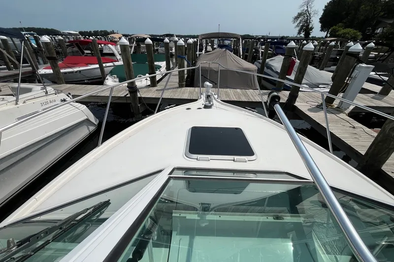 Slide: The Image of 2001 Tiara Yachts 2900 Coronet docked at a marina, surrounded by other boats. - 19